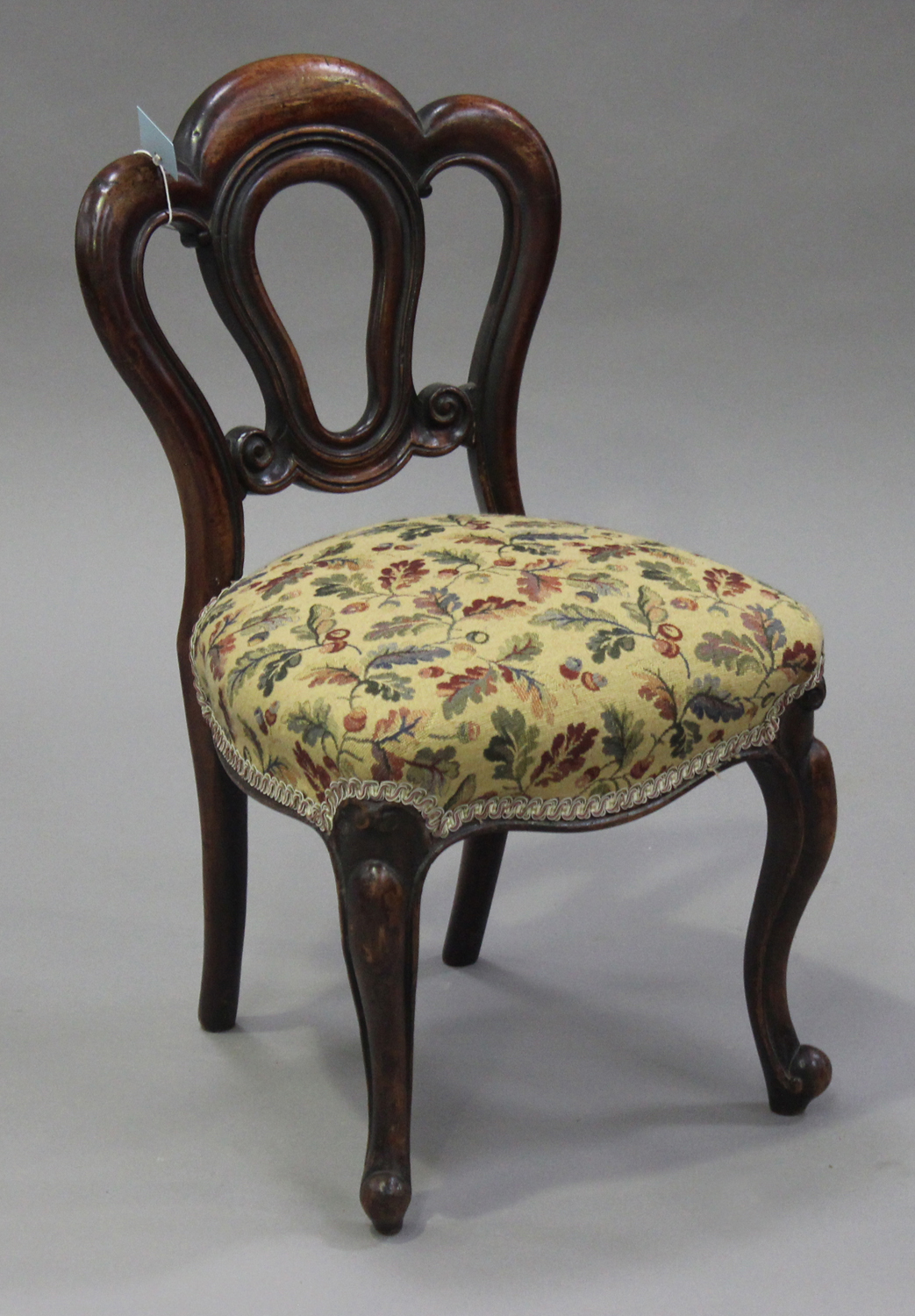 A late Victorian walnut framed child's chair with overstuffed seat, on cabriole legs, height 66cm,