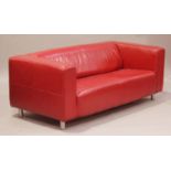 A late 20th century red leather low back two-seat sofa, on chromium plated feet, height 68cm,