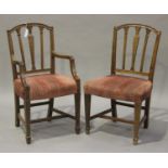A set of eight 20th century Hepplewhite style mahogany dining chairs with carved decoration,