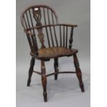 A mid-19th century yew, elm and ash Windsor armchair with a pierced splat back, the solid seat