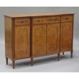 A late 20th century George III style walnut breakfront sideboard, fitted with three drawers above