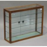 A mid-20th century oak glazed counter top display cabinet with glass shelves, height 61cm, width