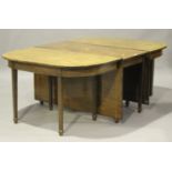 A 19th century mahogany 'D' end dining table, the satinwood crossbanded top with central drop-flap