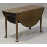 An early 20th century George III style mahogany oval drop-flap supper table, raised on turned legs