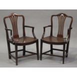 A pair of George III provincial mahogany elbow chairs with pierced splat backs and solid seats, on