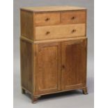 An early 20th century oak tallboy by Waring & Gillow Ltd, fitted with three drawers and two doors,
