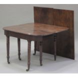 A George III mahogany fold-over extending dining table, fitted with two extra leaves, raised on