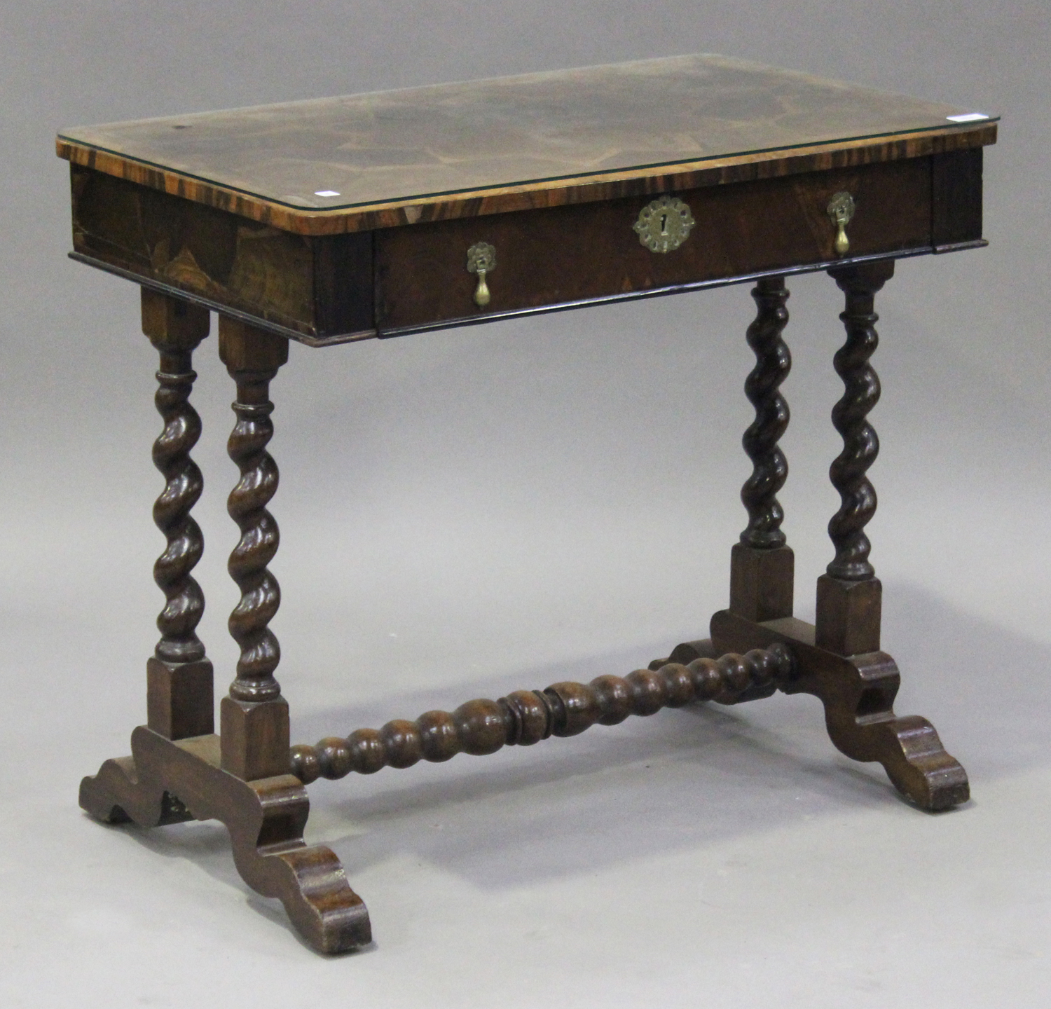 A 19th century oyster veneered and oak side table, fitted with a single frieze drawer, raised on