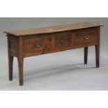 A late 19th/early 20th century French oak serving table, fitted with three drawers and an end slide,
