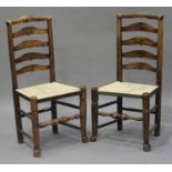 A pair of 19th century ash ladder back chairs with rush seats, on turned legs, height 95cm, width