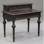 A late Victorian oak side table with carved decoration, the raised back fitted with a drawer above a