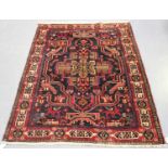 A Hamadan rug, North-west Persia, mid-20th century, the charcoal field with an angular medallion,