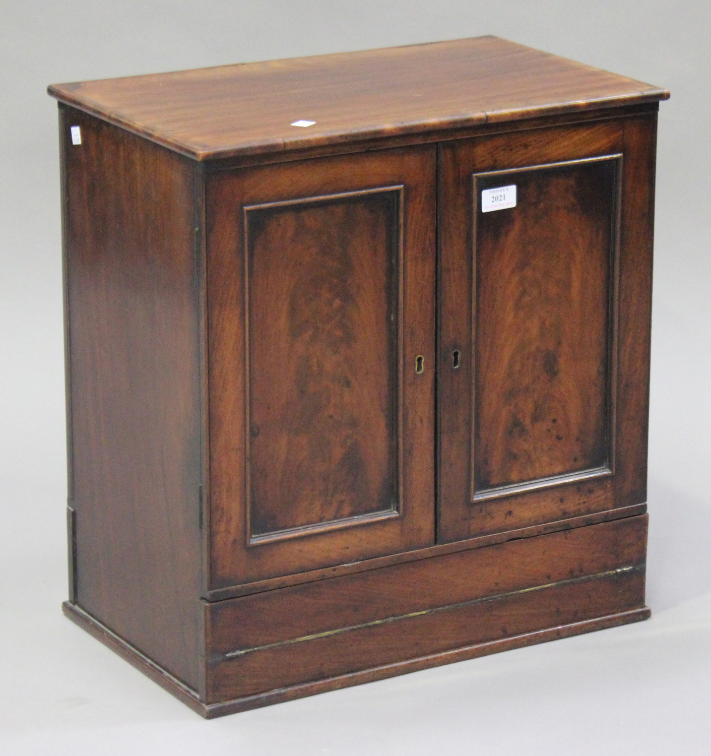 A Victorian mahogany writing cabinet, fitted with a pair of panel doors above a pull-out writing