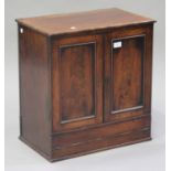 A Victorian mahogany writing cabinet, fitted with a pair of panel doors above a pull-out writing