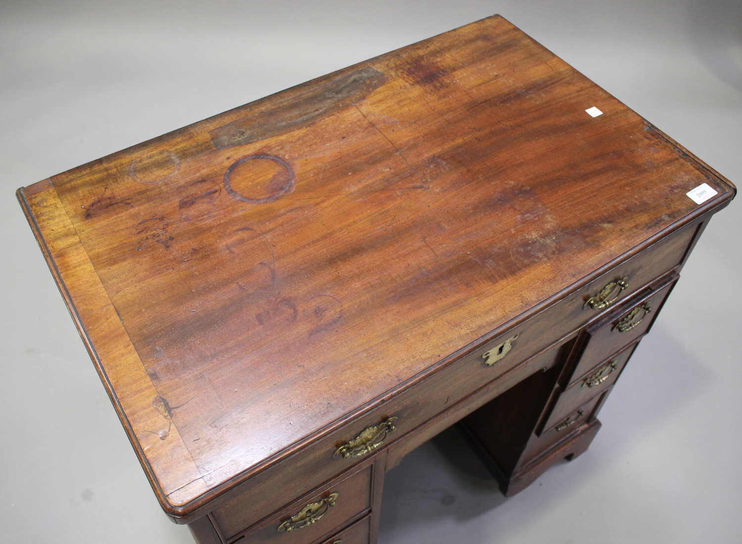 A George III mahogany kneehole desk, the moulded top above seven drawers and a cupboard, on - Image 2 of 2