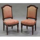 A set of ten late Victorian oak framed dining chairs with upholstered seats and backs, on turned