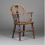 A mid-19th century yew, elm and ash Windsor armchair with a pierced splat back, the solid seat