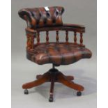 A 20th century reproduction mahogany and brown buttoned leather revolving office chair, height 87cm,