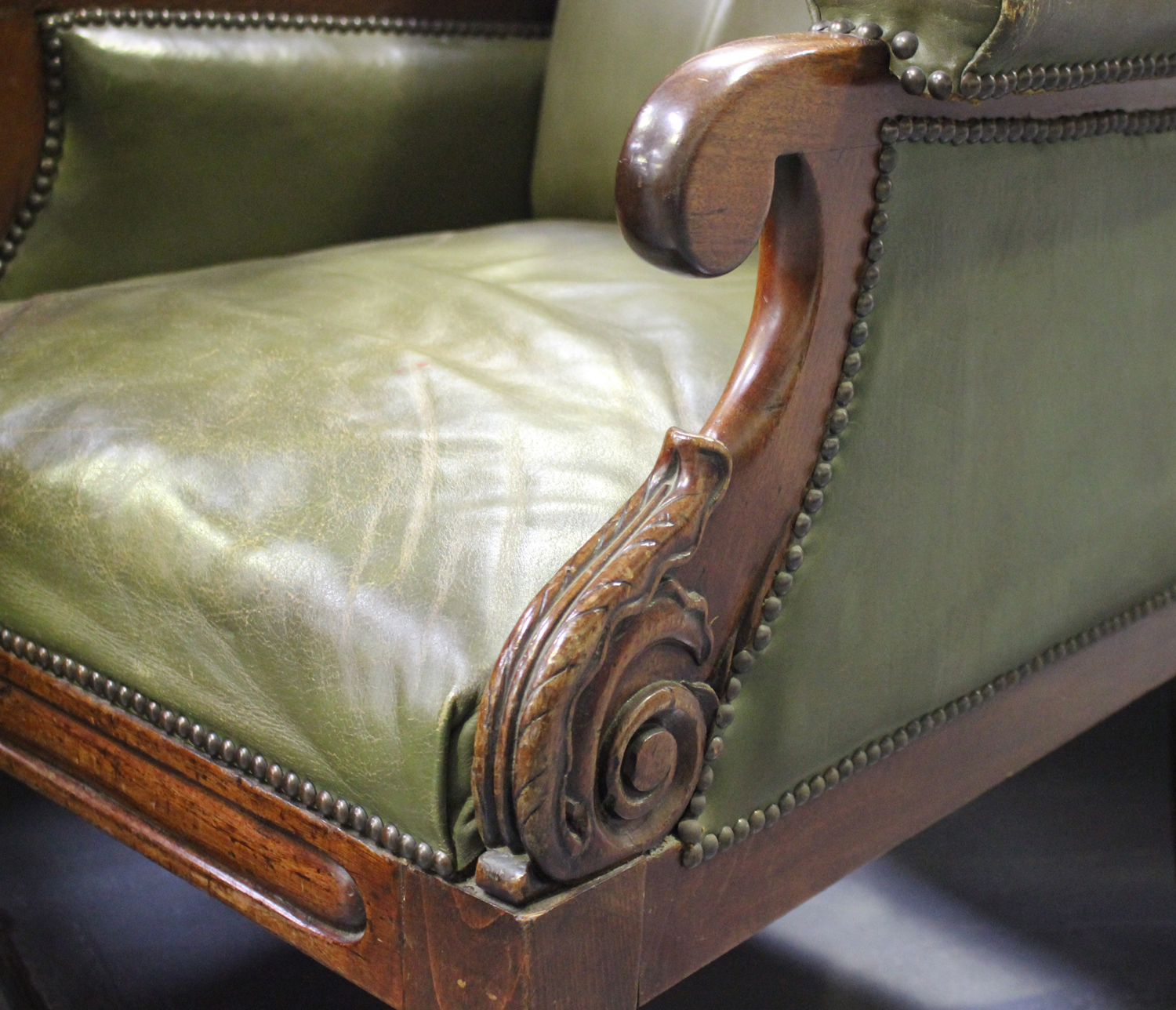 An early Victorian mahogany library armchair, upholstered in green buttoned leather, raised on - Image 2 of 2