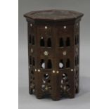 An early 20th century Eastern carved hardwood octagonal occasional table with pierced sides and