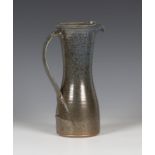 A Toff Milway pottery jug, dated 1998, of waisted form, covered in a speckled brown/blue glaze