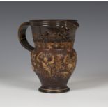 A Royal Doulton stoneware motto jug, circa 1900, the brown glazed body sprigged with Bacchanalian