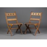 A pair of early 20th century Gothic style oak side chairs, the bar backs pierced with tracery