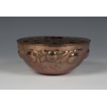 An Arts and Crafts Newlyn copper rose bowl, the pierced cover above a hammered body decorated with