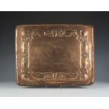 An Arts and Crafts Newlyn copper rectangular tray, worked in relief with a band of fish, shells,