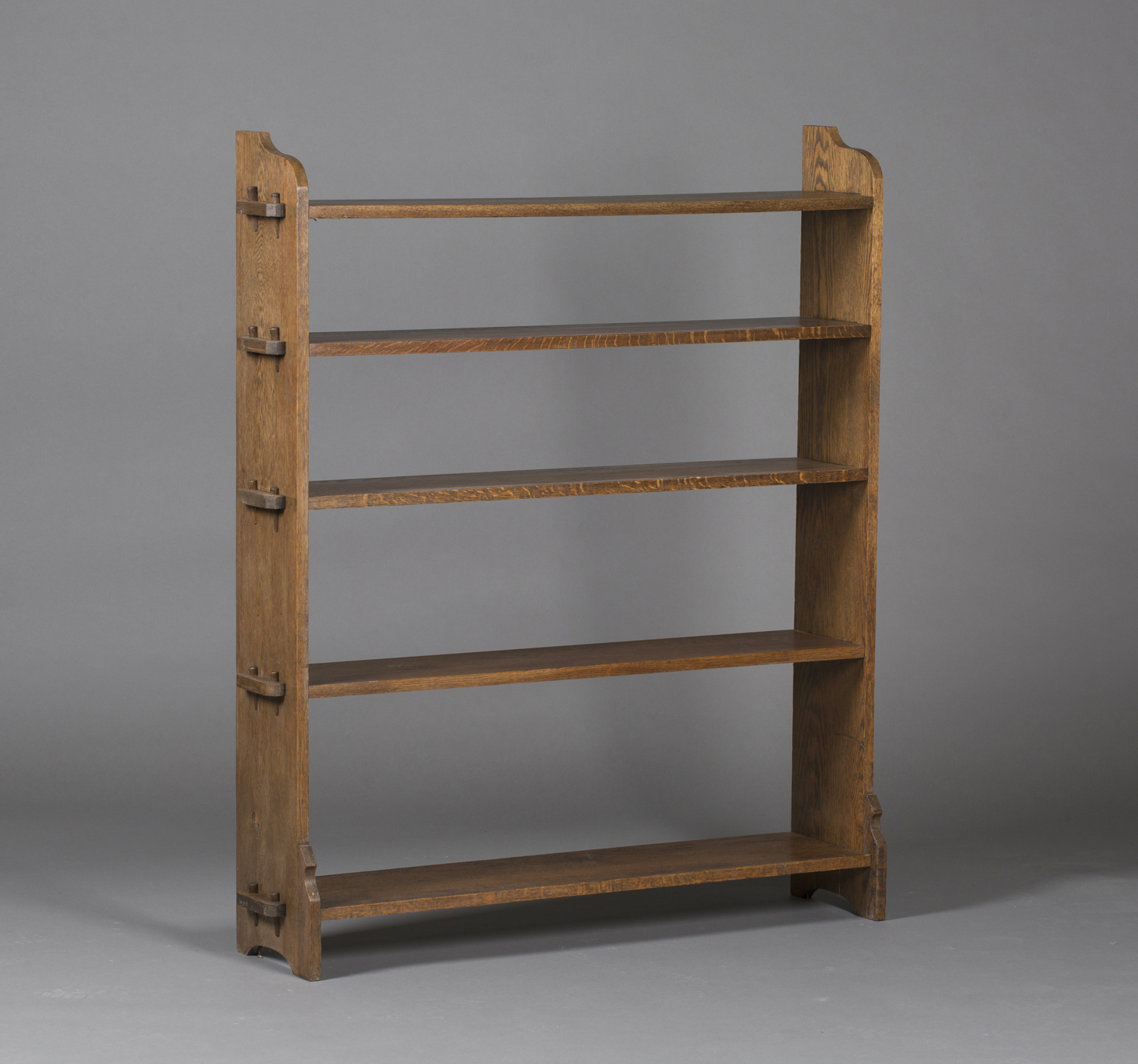 An early 20th century Arts and Crafts style oak five-tier open bookcase, in the manner of