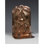 An Arts and Crafts copper twin light wall sconce, probably Newlyn, the wall plate decorated in