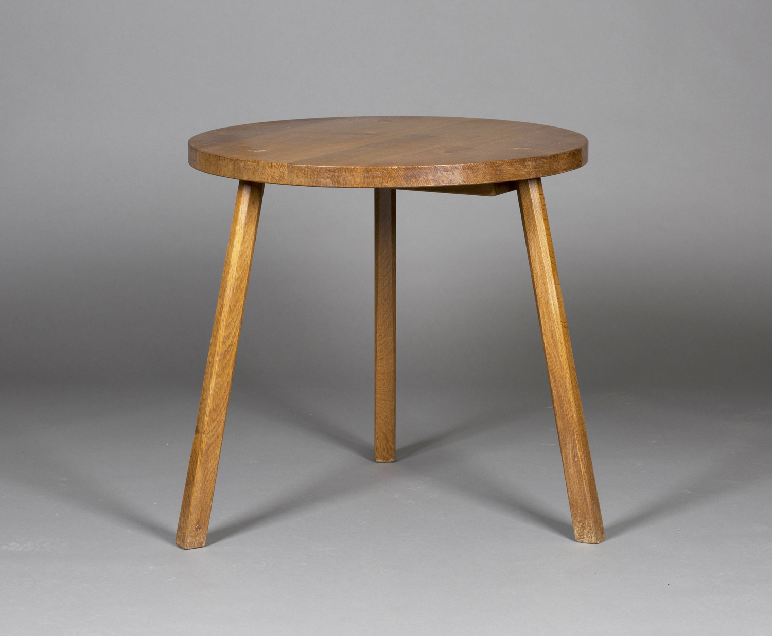 A Yorkshire School Arts and Crafts style oak circular supper table, in the manner of Robert '