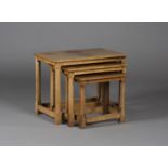 A Robert 'Mouseman' Thompson oak nest of three occasional tables, the lightly adzed tops raised on