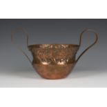 A large Keswick School of Industrial Arts copper twin-handled bowl, the hammered body with a concave