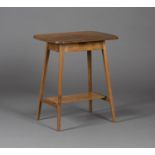 An early 20th century Arts and Crafts style oak occasional table, the curved rectangular top on