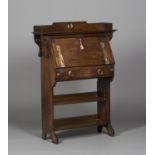 An Edwardian Arts and Crafts oak student's bureau, in the manner of Liberty & Co, the pierced