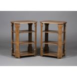 A pair of Edwardian Arts and Crafts oak four-tier book tables, in the manner of Liberty & Co, the