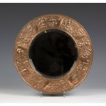 An Arts and Crafts copper mounted circular wall mirror, the bevelled plate within a wide frame