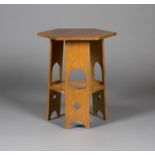 A 20th century Arts and Crafts style oak hexagonal occasional table, in the manner of the Glasgow