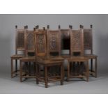 A set of eight late 19th/early 20th century Gothic Revival oak panel back side chairs, the chamfered