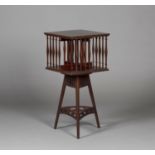 An Edwardian Arts and Crafts mahogany revolving bookcase-on-stand by Shapland & Petter, the square