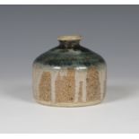 An Eric James Mellon studio pottery vase of compressed circular form with short narrow neck,