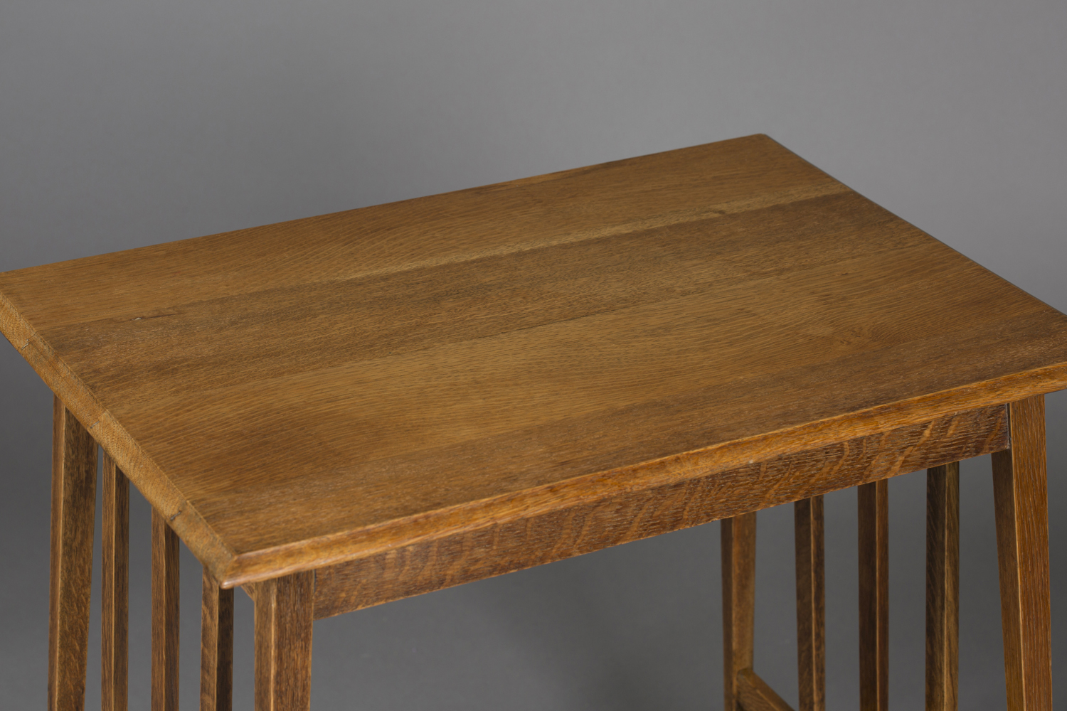 An Edwardian Arts and Crafts oak rectangular occasional table, in the manner of Liberty & Co, raised - Image 2 of 2