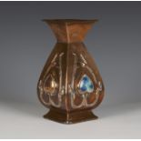 An Arts and Crafts copper vase of square section baluster form, the body worked with stylized