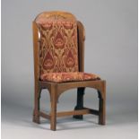 An Edwardian Arts and Crafts oak framed hall chair, attributed to E.G. Punnett, the arched top