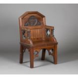 A late Victorian Gothic Revival ecclesiastical pitch pine armchair, in the manner of A.W.N. Pugin,