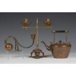 A late Victorian Gothic Revival brass and copper mounted two branch candelabrum, height 28cm,