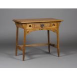 An early 20th century Arts and Crafts oak side table, in the manner of Liberty & Co, the frieze