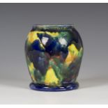 A Kate Malone studio pottery vase of high shouldered form, covered in splashes of blue, yellow,