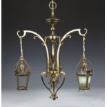 An Arts and Crafts gilt brass three branch ceiling light, in the manner of W.A.S. Benson, the